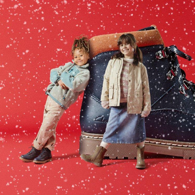 girl and boy standing next to kids boots